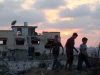 Palestinian boys walking in front of their house which was damaged in Israeli shelling in Gaza City, in Gaza City August 18, 2014. Prime Min...