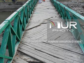 Kashmiri women walk over Eco park bridge of Baramulla,  located at the island in the middle of Jhelum river on 7 September 2017. Baramulla t...