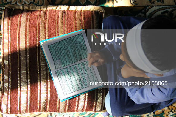 Muslim Girl Reading Quran in Bandipora district in the Indian state of Jammu and Kashmir.  
