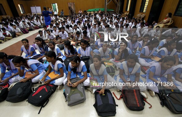 Students of a government school sit in an awareness program organized by social workers about the adolescents of mental health on the Intern...