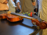 A victim's violin is pictured on the opening day of the September 12 Shame Museum, which is held with the help of the main opposition Republ...