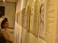A woman looks at portraits of the victims on the opening day of the September 12 Shame Museum, which is held with the help of the main oppos...