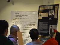People look at a board on the opening day of the September 12 Shame Museum, which is held with the help of the main opposition Republican Pe...