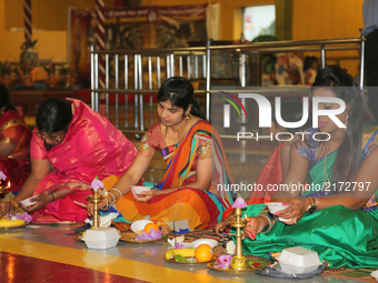 Tamil Hindu women participate in special prayers during Varalaxmi Pooja (Varamahalakshmi Vrata) at a Tamil Hindu temple in Toronto, Ontario,...