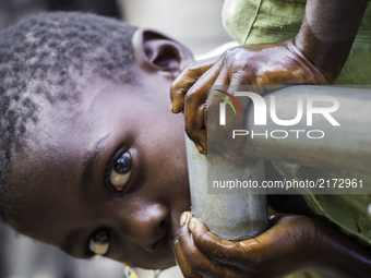 A child enjoys fresh water for the first time in Malawi, Africa, (