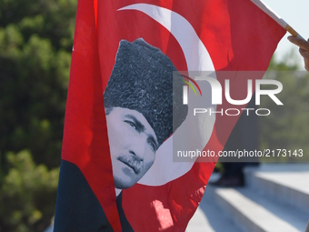 A man holds a Turkish flag during a march marking the 94th anniversary of the main opposition Republican People's Party (CHP) at Anitkabir,...