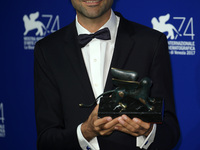 Alireza Khatam poses with the Orizzonti Award for Best Screenplay Award for 'Los Versos Del Olvido' (Oblivion Verses) at the Award Winners p...