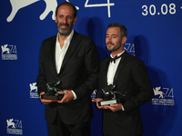 Xavier Legrand (R) and Alexandre Gavras pose with the Silver Lion for Best Director Award for 'Jusqu' la Garde' and the 'Luigi De Laurentiis...