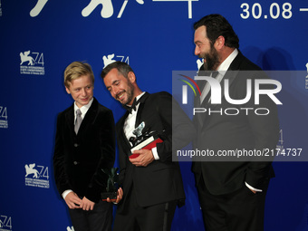 Thomas Gioria, Xavier Legrand and Denis Menochet pose with the Silver Lion for Best Director Award for 'Jusqu' la Garde' and the 'Luigi De L...