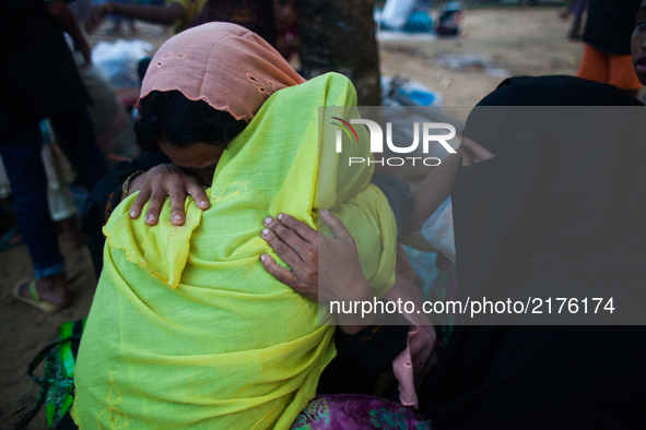 Rohingya Muslim refugees are crying holding eachother at a temporary makeshift shelters after crossing over from Myanmar into the Bangladesh...