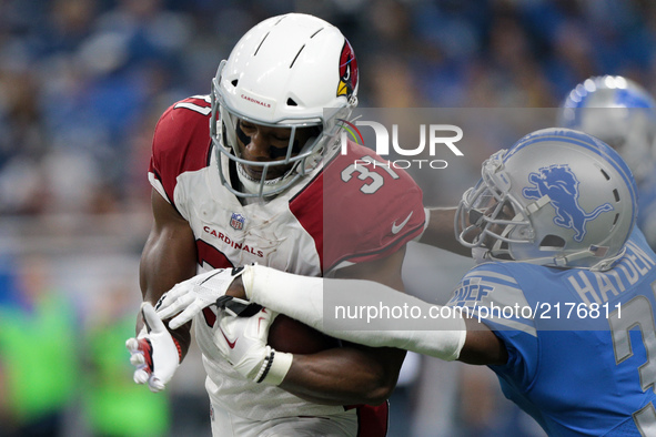 Arizona Cardinals running back David Johnson (31) is tackled by Detroit Lions defensive back D.J. Hayden (31) during the second half of an N...