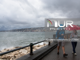 The tourists in Golfo of Naples, Via Partenope, View of Rain and Storm to Naples, Italy on 11 September , 2017. Some storms will produce hea...