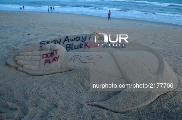 Indian sand artist Sudarshan Patnaik is creating a sand sculpture about the Blue Whale game for public awareness at the Bay of Bengal Sea’s...