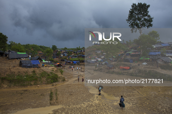 Rohingya Muslim refugees are at a temporary makeshift shelters after crossing over from Myanmar into the Bangladesh side of the border, near...