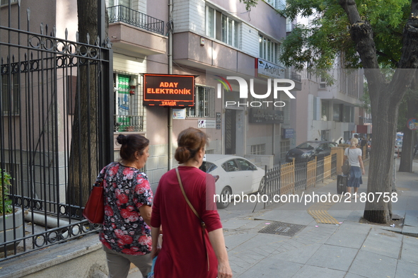 Two women walk past the People's Law Office's building after an anti-terror operation targeting the lawyers of arrested hunger strikers Nuri...