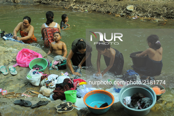 Residents take water, bathe, and wash the cihoe river clothes that begin to recede in the village Ridogalih, Cibarusah, Bekasi, West Java on...