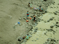 Residents take water, bathe, and wash the Cipamingkis river clothes that begin to recede, Cibarusah, Bekasi, West Java on September 13, 2017...