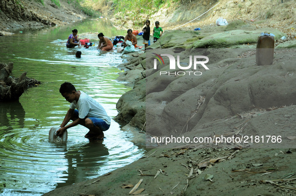Residents take water, bathe, and wash the cihoe river clothes that begin to recede in the village Ridogalih, Cibarusah, Bekasi, West Java on...