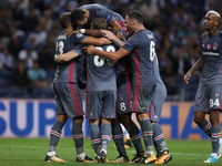 Besiktas' forward Ryan Babel (C) celebrates after scoring during the FC Porto v Besiktas - UEFA Champions League Group G round one match at...