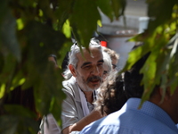 A man can be seen as people gathered outside the main courthouse prior to the first trial of arrested hunger strikers Nuriye Gulmen and Semi...