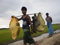 Rohingya ethnic minority people fleeing to a temporary makeshift camp, after crossing over from Myanmar into the Bangladesh side of the bord...