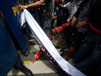 An indigenous woman protester falls to the ground following a clash with riot policemen during a rally against alleged US involvement in mil...