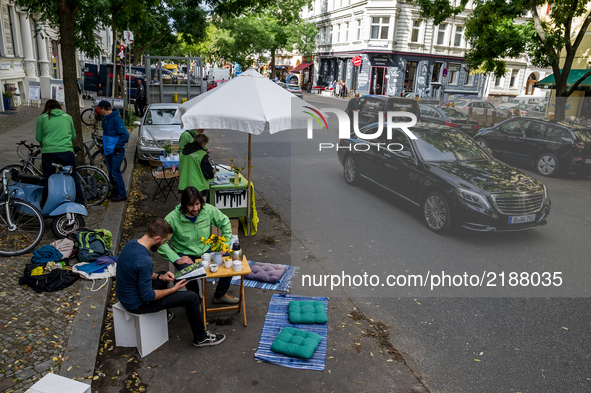 Greenpeace activists drink tea in a parking lot in Berlin, Germany, on 15 September 2017. In the annual worldwide action, artists, designers...