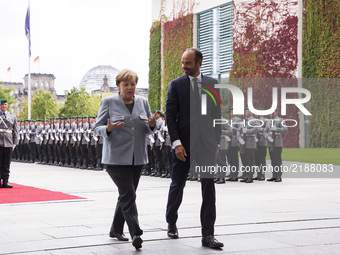 German Chancellor Angela Merkel and  French Prime Minister Edouard Philippe enter the Chancellery after reviewing the guard of honour in Ber...