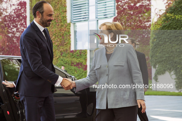 German Chancellor Angela Merkel greets French Prime Minister Edouard Philippe upon his arrival at the Chancellery in Berlin on September 15,...
