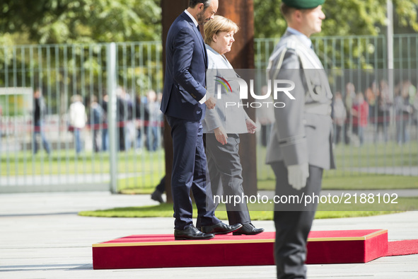 German Chancellor Angela Merkel and French Prime Minister Edouard Philippe arrive to listen to the national anthems at the Chancellery in Be...