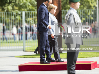 German Chancellor Angela Merkel and French Prime Minister Edouard Philippe arrive to listen to the national anthems at the Chancellery in Be...