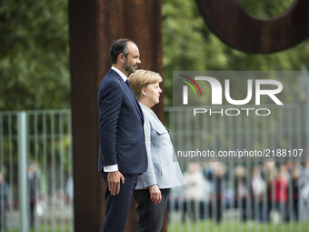 German Chancellor Angela Merkel and French Prime Minister Edouard Philippe listen to the national anthems at the Chancellery in Berlin on Se...