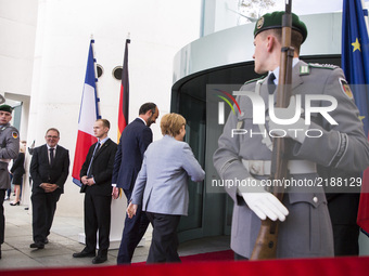 German Chancellor Angela Merkel and  French Prime Minister Edouard Philippe enter the Chancellery after reviewing the guard of honour in Ber...