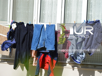 Washing clothes can be seen on a clothesline in front of a balcony during a hot autumn day in Ankara, Turkey on September 15, 2017. Extreme...