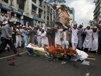Bangladeshi Muslims burn Aung San Suu Kyis coffin and Myanmar national flag to protest against Rohgingya Muslims killing in Rakhine states i...