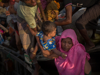 A Rohingya mother holds her child after getting off the boat. Shahpirer Dip, Teknaf, Bangladesh; September 14, 2017. Bangladesh will use tro...