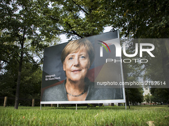 An election poster of German Chancellor Angela Merkel (CDU) is pictured in the district of Lichtenberg in Berlin, Germany on September 15, 2...