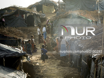 Rohingya people stands close to their makeshift tent at the Balukhali camp in Ukhiya, Bangladesh 15 September 2017. Many of the Rohingya fle...