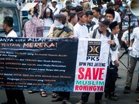 Members of Indonesian Islam-based Prosperous Justice Party (PKS) hold banners and shout slogans during a protest in Semarang, Central Java P...