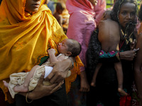 A Refugee woman with her 6 days new born baby wait for relief at palong khali, Cox’s Bazar, Bangladesh September 16, 2017. Around 370,000 Ro...