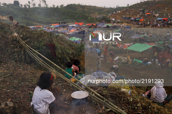 Rohingya girl prepare food in the side of her makeshift tent at the Thenkhali refugee camp in Cox’s Bazar, Bangladesh September 16, 2017. Ar...