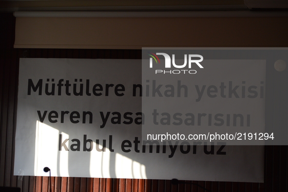 A banner reading 'We do not accept the law proposal that authorizes muftis to perform marriages' is pictured prior to women's meeting agains...