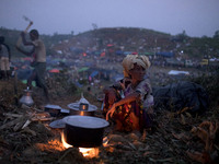 Rohingya woman prepare food in front of her makeshift tent at the Thenkhali refugee camp in Cox’s Bazar, Bangladesh September 16, 2017. Arou...