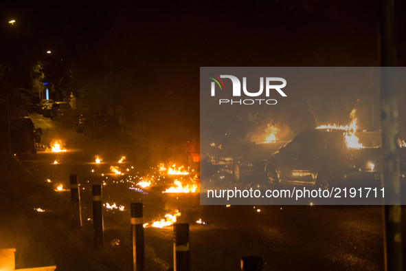 Cars in flames from molotof coctails during an anti-fascism demonstration in Athens on September 16, 2017 