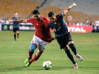 Ahly player Ahmed Fathi ( L ) and Esperance player Anis ( R ) during the CAF Champions League quarterfinal first-leg football match between...