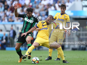 
Francesco Magnanelli of Sassuolo and Gonzalo Higuain of Juventus  during the Serie A match between US Sassuolo and Juventus at Mapei Stadiu...
