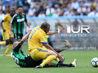 
Paolo Cannavaro of Sassuolo tackling on Gonzalo Higuain of Juventus  during the Serie A match between US Sassuolo and Juventus at Mapei Sta...