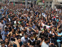 Palestinians carry the bodies of three senior Hamas commanders, who were killed in an Israeli air strike, during their funeral in Rafah in t...