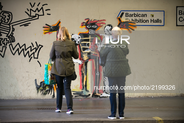 Two artworks by Banksy are pictured at the Barbican centre in central London, on September 18, 2017. The murals, inspired by the upcoming Je...