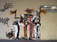 Two artworks by Banksy are pictured at the Barbican centre in central London, on September 18, 2017. The murals, inspired by the upcoming Je...
